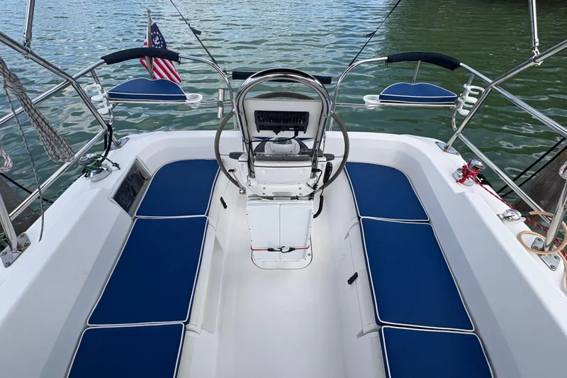 Slide: The Image of Cockpit of 2006 Hunter 31 sailboat with blue seating and steering wheel. - 13