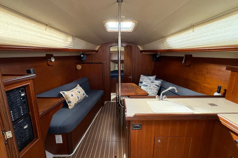 Slide: The Image of Interior of a 2006 Hunter 31 sailboat with wood finish and cozy seating. - 2
