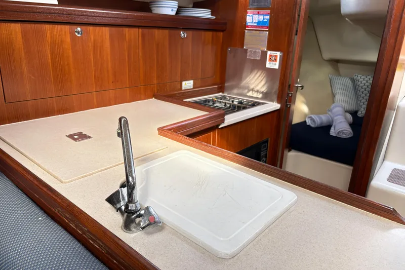 Slide: The Image of Interior of 2006 Hunter 31 sailboat kitchen with sink, stove, and cozy cabin. - 9