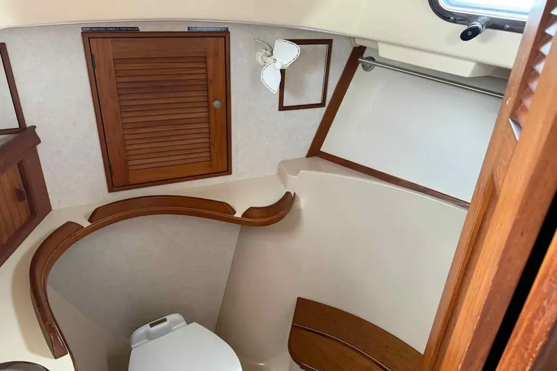 Slide: The Image of 1998 Island Packet 40 yacht bathroom with wooden cabinetry and compact toilet. - 14