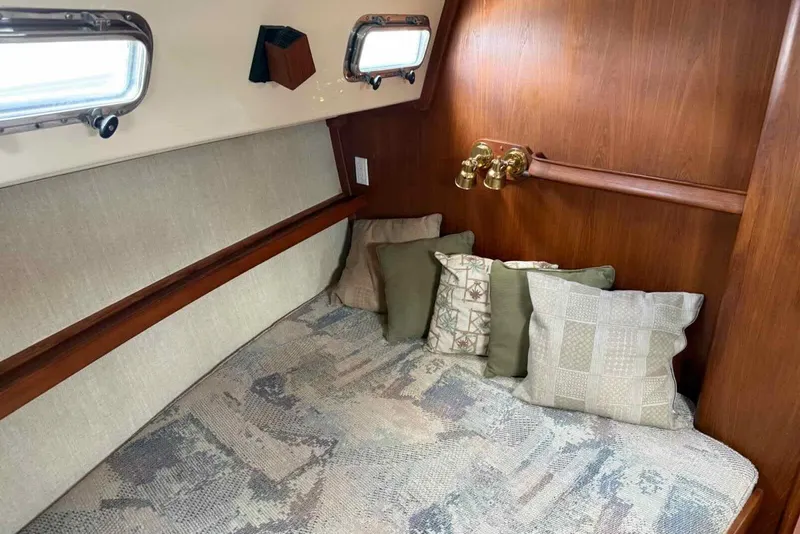 Slide: The Image of Cozy cabin interior of 1998 Island Packet 40 sailboat with cushions and wooden paneling. - 15