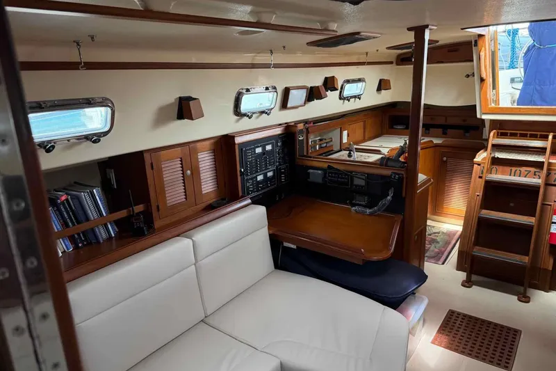 Slide: The Image of Interior of 1998 Island Packet 40 sailboat with cozy seating and navigation area. - 16