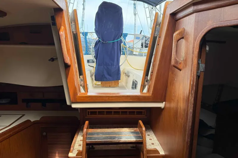 Slide: The Image of Interior view of a 1998 Island Packet 40 sailboat, showcasing wooden cabin details. - 17