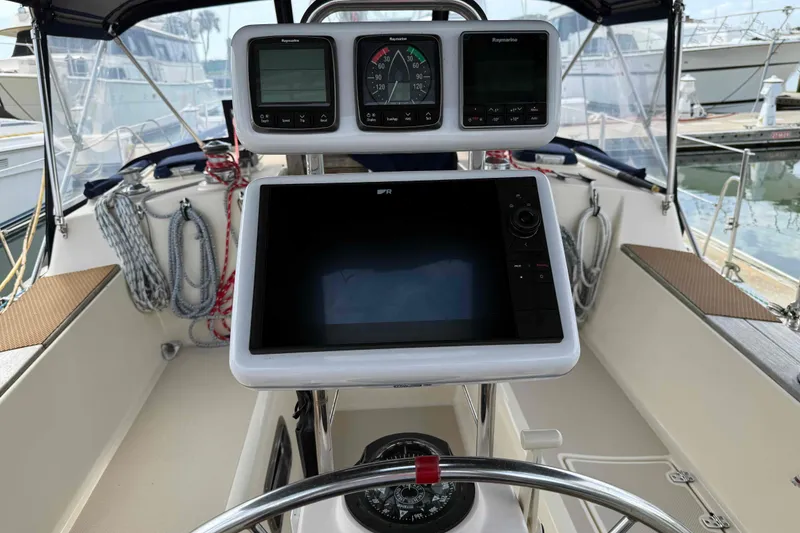 Slide: The Image of Cockpit of 1998 Island Packet 40 sailboat with navigation instruments and steering wheel. - 19