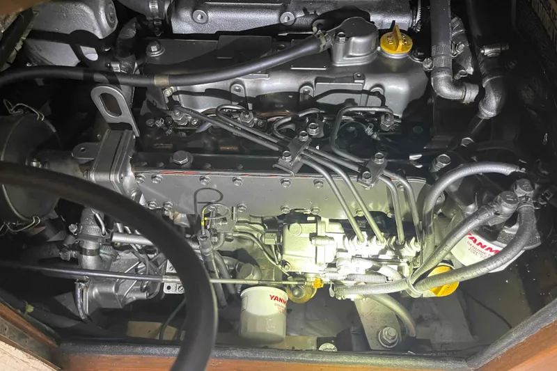 Slide: The Image of Engine compartment of a 1998 Island Packet 40 sailboat, featuring Yanmar components. - 31