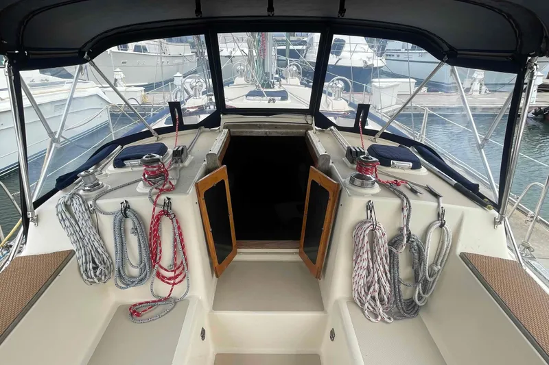 Slide: The Image of Cockpit of 1998 Island Packet 40 sailboat with ropes and winches, docked at marina. - 33