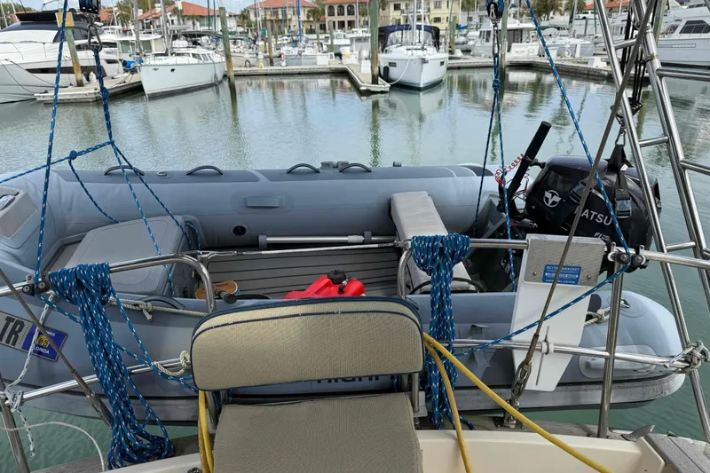 Slide: The Image of 1998 Island Packet 40 sailboat with dinghy and outboard motor in marina setting. - 35