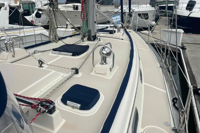 Slide: The Image of 1998 Island Packet 40 sailboat deck with winches and rigging at marina. - 42