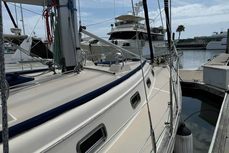 Slide: The Image of 1998 Island Packet 40 sailboat docked at marina, showcasing deck and rigging. - 43