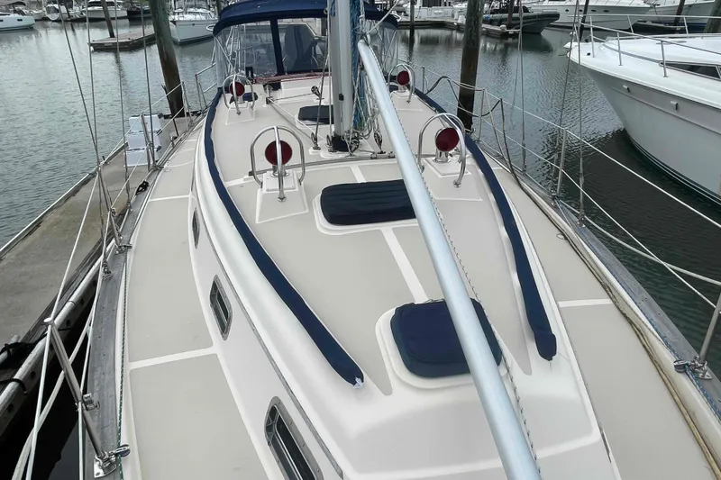 Slide: The Image of 1998 Island Packet 40 sailboat docked at marina, showcasing deck and rigging. - 45