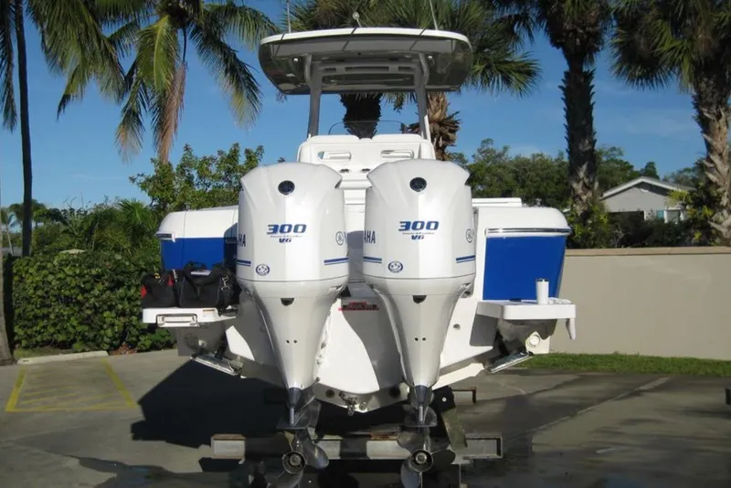 Slide: The Image of 2020 Intrepid 327 Center Console boat with twin Yamaha 300 engines, parked outdoors. - 3