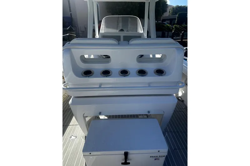 Slide: The Image of 2020 Intrepid 327 Center Console boat interior with rod holders and storage compartment. - 6
