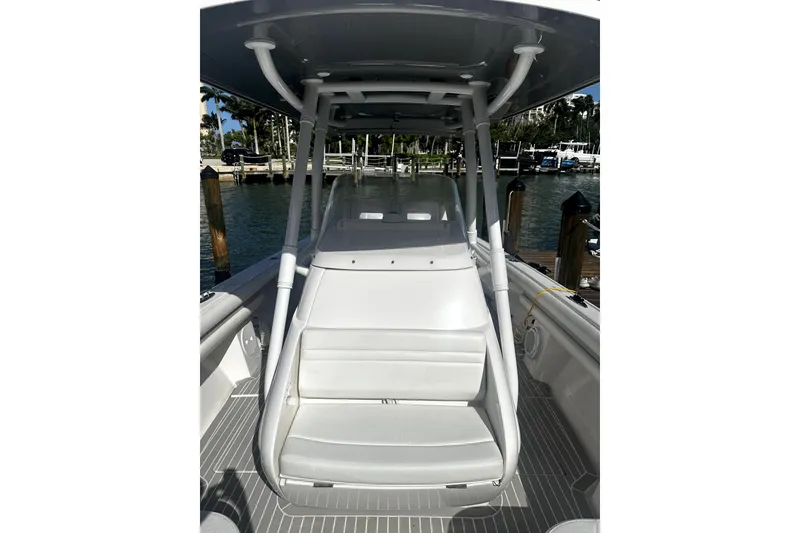 Slide: The Image of 2020 Intrepid 327 Center Console boat docked, showcasing sleek seating and modern design. - 9