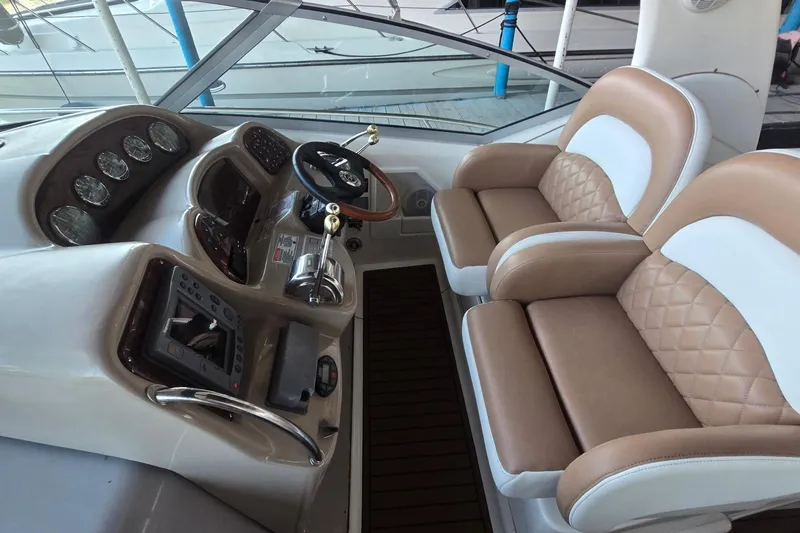 Slide: The Image of Helm of 2005 Sea Ray 340 Sundancer with dual seats and modern controls. - 10
