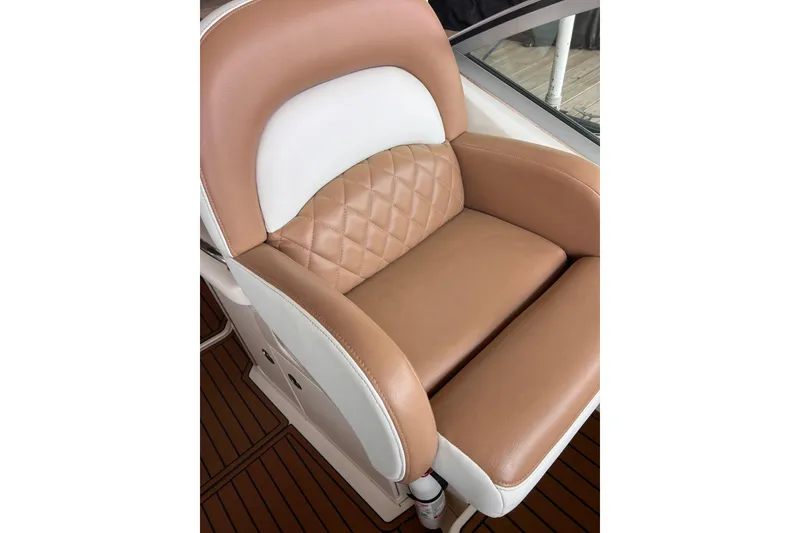 Slide: The Image of Luxurious tan and white leather seat on 2005 Sea Ray 340 Sundancer boat. - 14