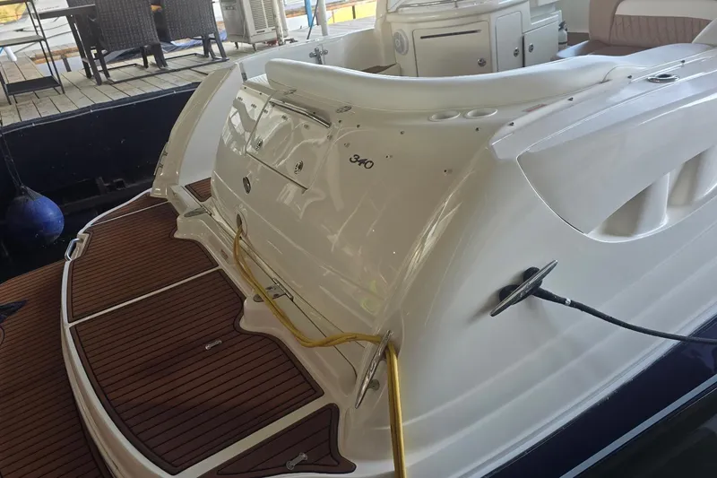 Slide: The Image of 2005 Sea Ray 340 Sundancer boat with teak swim platform and docked at marina. - 20