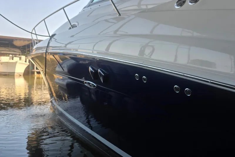 Slide: The Image of 2005 Sea Ray 340 Sundancer yacht docked, reflecting on calm water. - 24