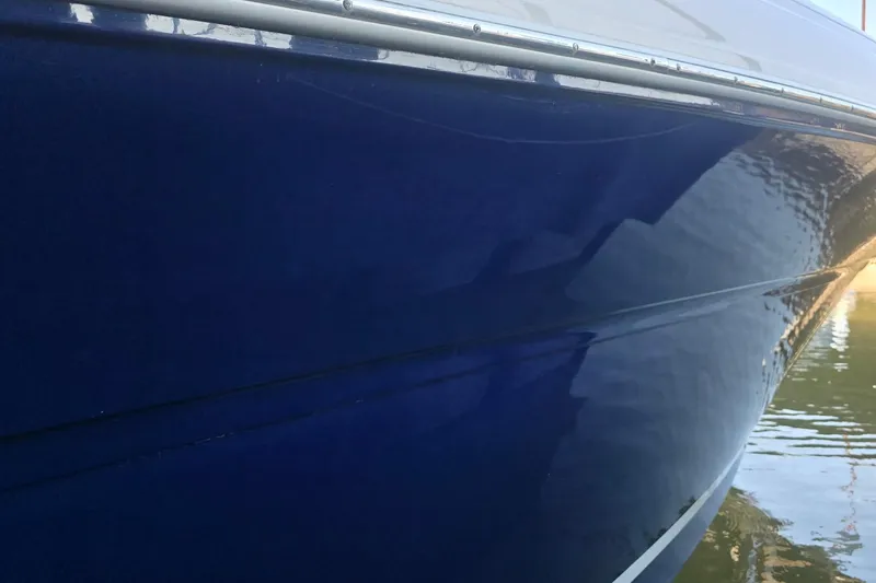Slide: The Image of Close-up of a 2005 Sea Ray 340 Sundancer boat hull reflecting water. - 28
