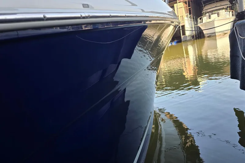 Slide: The Image of 2005 Sea Ray 340 Sundancer yacht docked, reflecting on calm water. - 29