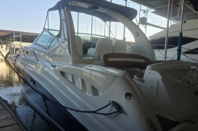 Slide: The Image of 2005 Sea Ray 340 Sundancer docked in marina, showcasing sleek design and luxury features. - 8