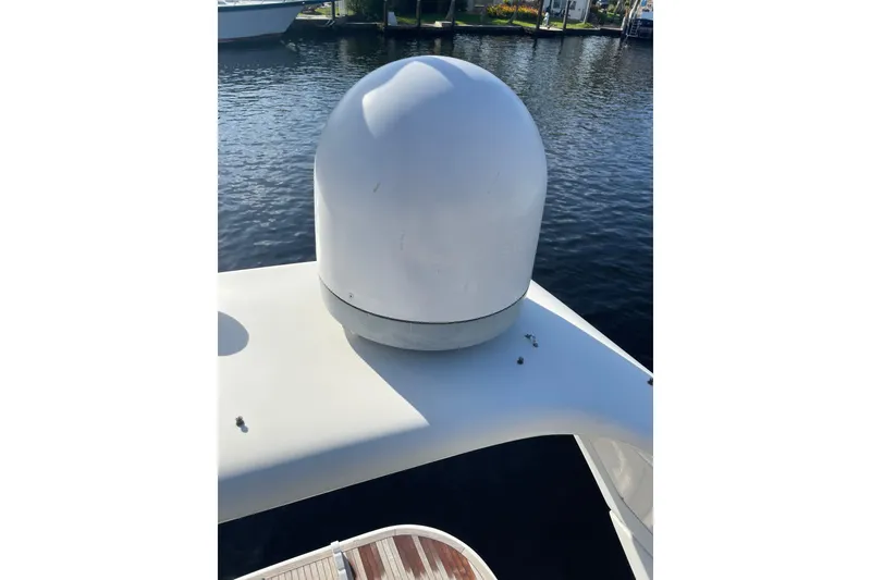 Slide: The Image of Radar dome on 2000 Azimut 46 Flybridge yacht, docked by calm waters. - 103