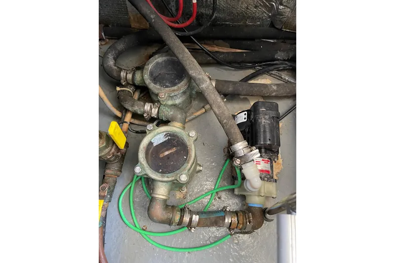 Slide: The Image of Engine room components of a 2000 Azimut 46 Flybridge MY yacht, featuring hoses and valves. - 108