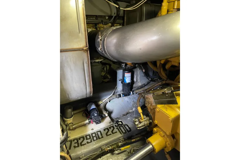 Slide: The Image of Engine room of 2000 Azimut 46 Flybridge MY, showcasing mechanical components and piping. - 109