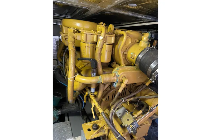 Slide: The Image of Engine compartment of 2000 Azimut 46 Flybridge MY yacht, showcasing intricate machinery. - 112