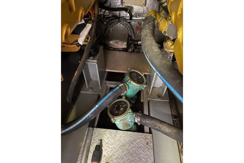 Slide: The Image of Engine room of 2000 Azimut 46 Flybridge MY with visible hoses and components. - 114