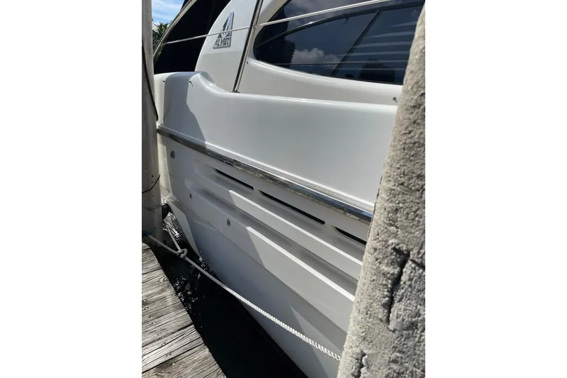 Slide: The Image of Side view of a 2000 Azimut 46 Flybridge MY yacht docked at a marina. - 12