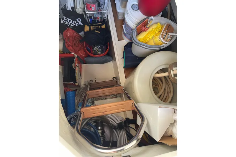 Slide: The Image of Storage compartment on a 2000 Azimut 46 Flybridge MY, filled with various boating supplies. - 122