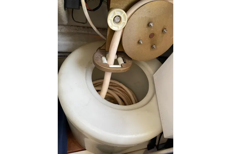 Slide: The Image of Storage compartment on a 2000 Azimut 46 Flybridge MY, filled with various boating supplies. - 125