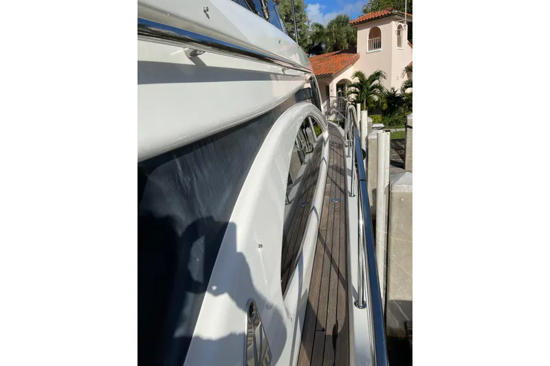 Slide: The Image of Azimut 46 Flybridge MY 2000 yacht docked, showcasing sleek design and wooden deck. - 13
