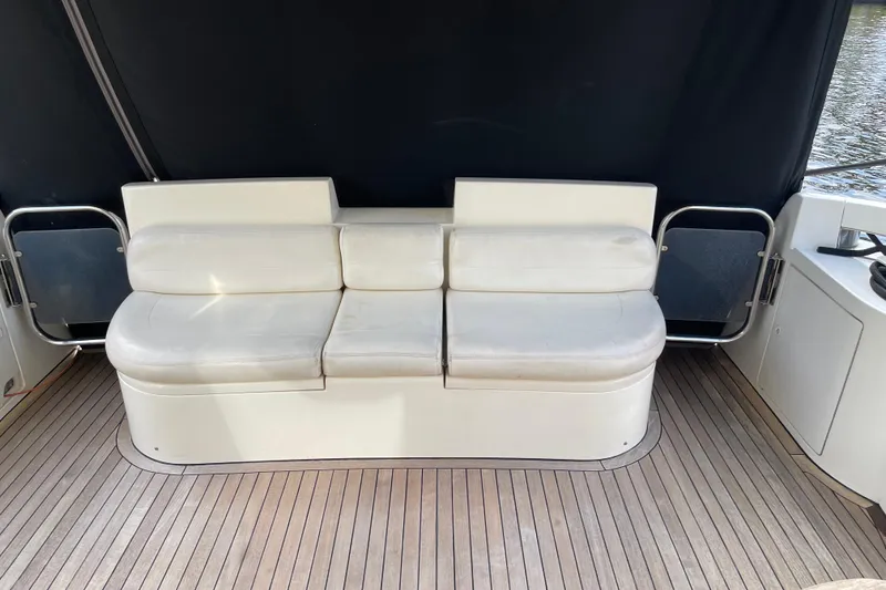Slide: The Image of White leather seating on Azimut 46 Flybridge MY, 2000 model, with wooden deck flooring. - 17