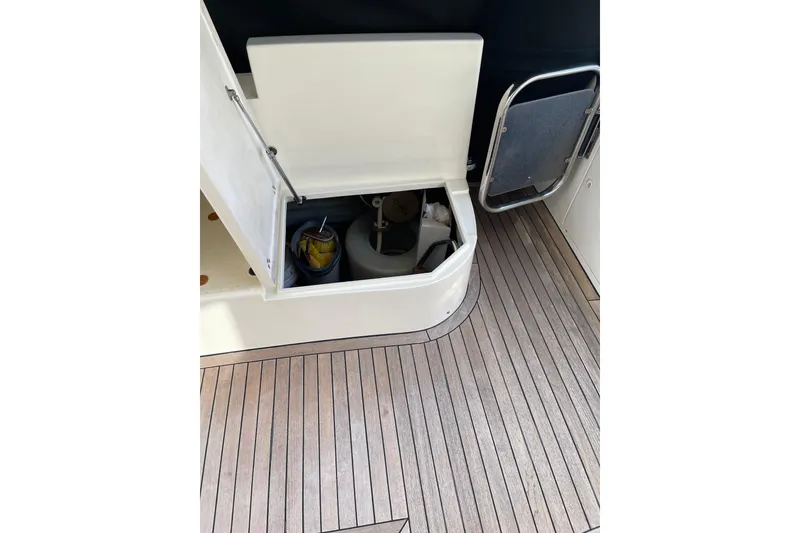 Slide: The Image of Open storage compartment on 2000 Azimut 46 Flybridge MY yacht with wooden deck. - 18