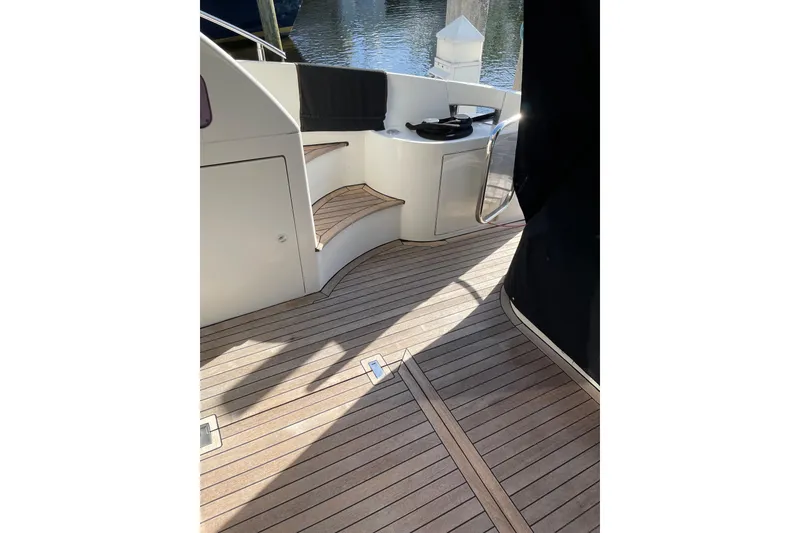 Slide: The Image of Azimut 46 Flybridge MY 2000 yacht deck with wooden flooring and seating area. - 21
