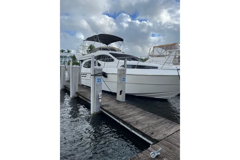 Slide: The Image of Azimut 46 Flybridge MY 2000 yacht docked at marina under cloudy sky. - 3