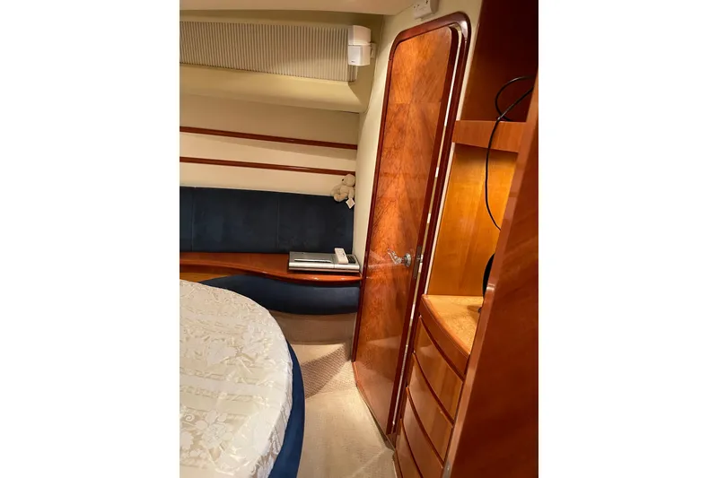 Slide: The Image of Luxurious interior of 2000 Azimut 46 Flybridge yacht with wood finishes and cozy seating. - 31