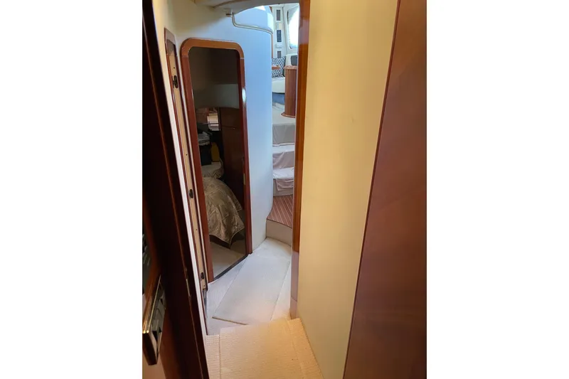 Slide: The Image of Interior hallway of 2000 Azimut 46 Flybridge yacht, featuring wood accents and carpeted flooring. - 36