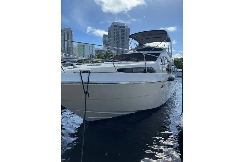 Slide: The Image of Azimut 46 Flybridge MY 2000 yacht docked, city skyline in background. - 4