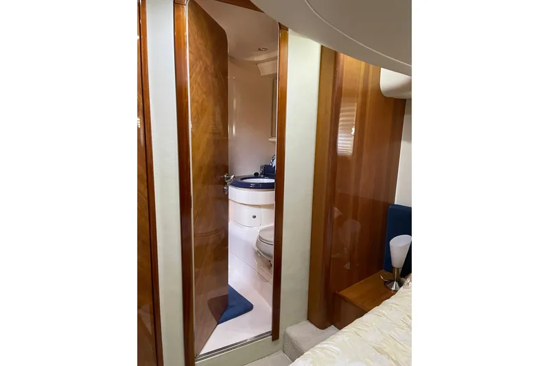 Slide: The Image of Luxurious bathroom interior of 2000 Azimut 46 Flybridge yacht, featuring wood accents and modern fixtures. - 42