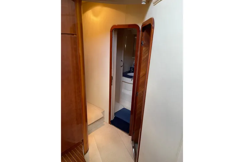 Slide: The Image of Interior view of 2000 Azimut 46 Flybridge MY yacht, featuring hallway and bathroom. - 45