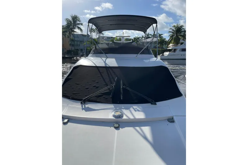 Slide: The Image of 2000 Azimut 46 Flybridge MY yacht with sunshade, docked near palm trees. - 5