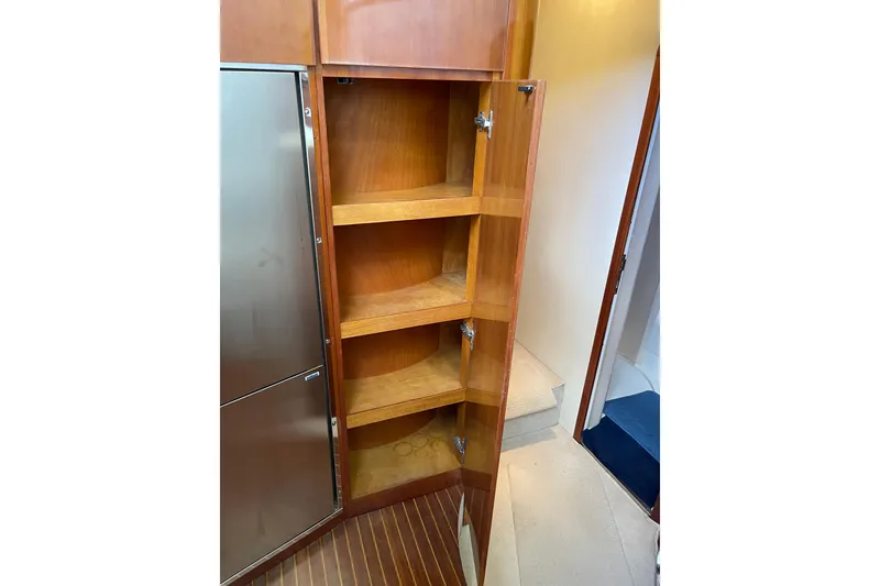 Slide: The Image of Wooden cabinet with open shelves inside a 2000 Azimut 46 Flybridge MY yacht. - 50