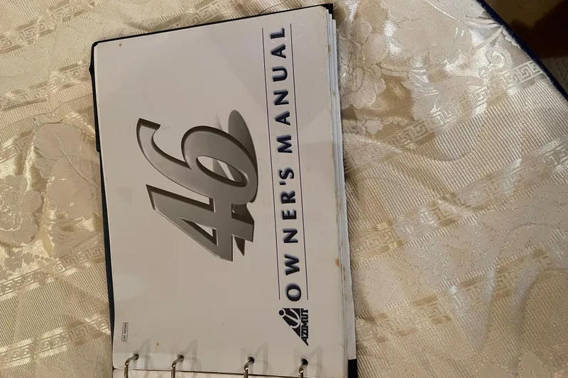 Slide: The Image of Azimut 46 Flybridge MY 2000 owner's manual on a patterned tablecloth. - 51