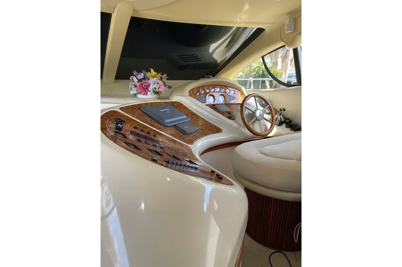 Slide: The Image of Luxurious helm of 2000 Azimut 46 Flybridge MY with wood accents and floral decor. - 56