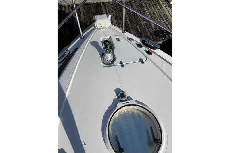 Slide: The Image of Bow view of 2000 Azimut 46 Flybridge MY yacht, featuring deck details and hatch. - 6