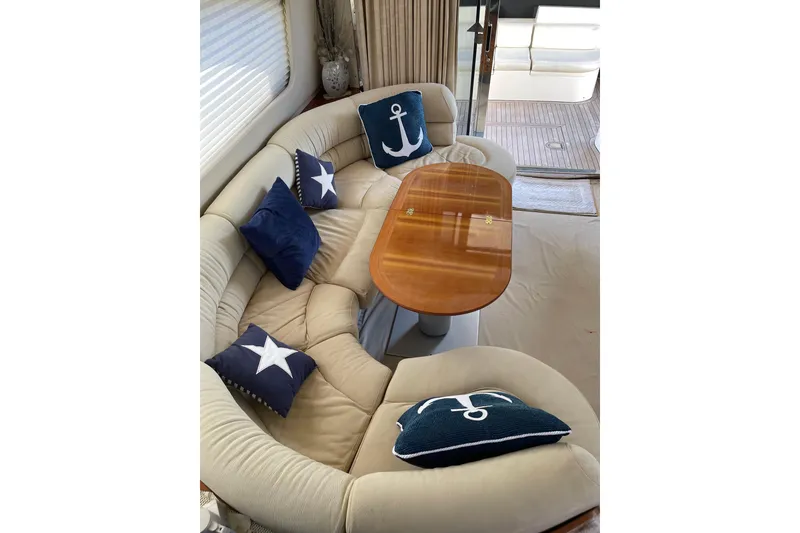 Slide: The Image of Luxurious Azimut 46 Flybridge MY 2000 yacht interior with elegant seating and nautical-themed cushions. - 60