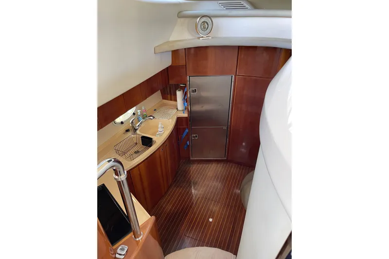 Slide: The Image of Luxurious kitchen interior of 2000 Azimut 46 Flybridge MY yacht with wood finish. - 62