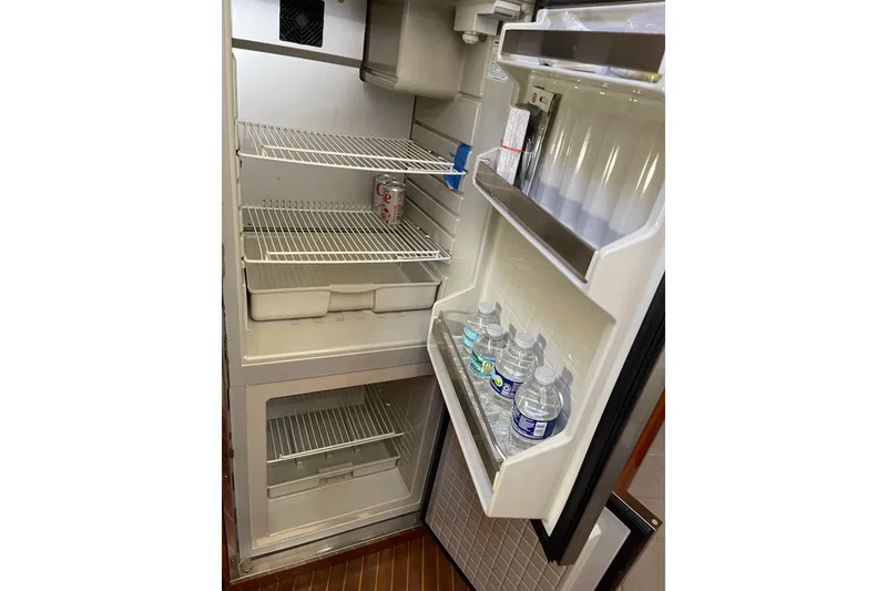 Slide: The Image of Open fridge on 2000 Azimut 46 Flybridge MY with drinks and empty shelves. - 63